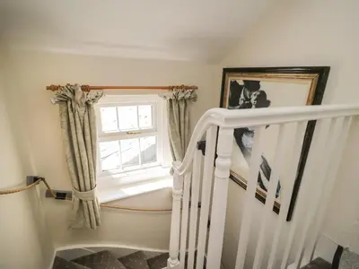 a stairway with a window and a stair case at Coombs View in Low Hesket