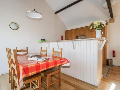 a kitchen and dining room with a table and chairs at Esthers Barn in Cockermouth