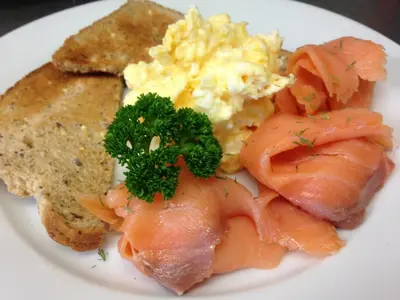 a plate of breakfast food with salmon scrambled eggs and toast at Embleton Spa Hotel & Apartments in Embleton