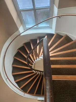 a spiral staircase in a building with a window at The Queensberry Hotel in Dumfries