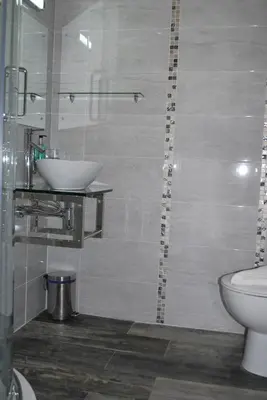 a bathroom with a sink and a toilet at Ellan Vannin Hotel in Douglas