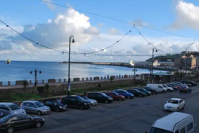 a row of cars parked in a parking lot near the water at Ellan Vannin Hotel in Douglas