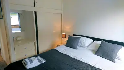 a bedroom with a bed with two towels on it at 4 Laigh Isle in Isle of Whithorn