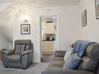 a living room with two chairs and a couch at Bobbin Cottage in Keswick