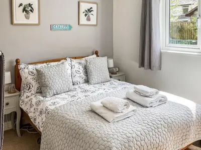 a bedroom with a bed with towels on it at Briargarth in Keswick