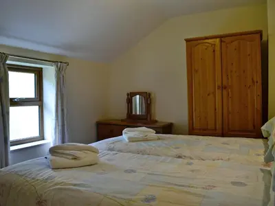 a bedroom with a large bed with two towels on it at Grajo Cottage - Uk1284 in Threlkeld