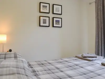 a bedroom with a bed and three pictures on the wall at Apple Tree Cottage in Bassenthwaite