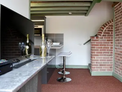a kitchen with a counter and a bar with a bar stool at Darci's Lodge - Uk1297 in Threlkeld