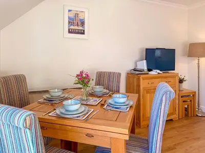 a dining room with a wooden table with chairs at Hindscarth in Keswick