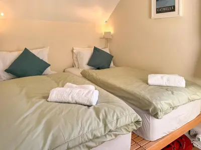 two beds sitting next to each other in a room at Hindscarth in Keswick