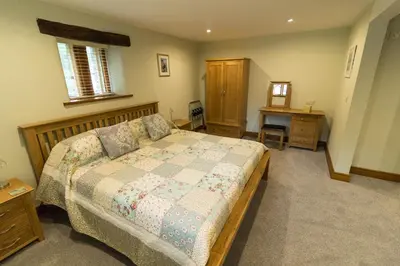 a bedroom with a bed with a quilt on it at Lords Seat Bed & Breakfast in Keswick