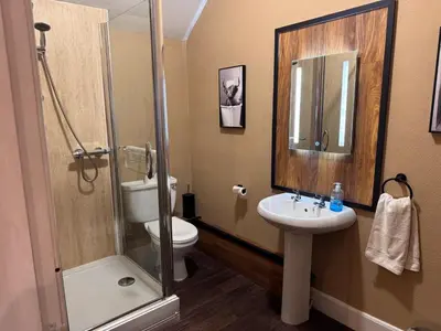 a bathroom with a shower and a toilet and a sink at Ernespie House Hotel in Castle Douglas