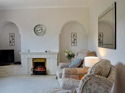 a living room with two couches and a fireplace at Ingleside in Ballantrae