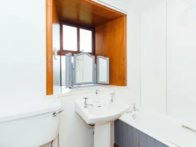 a bathroom with a sink and a mirror at The Bothy - Uk5803 in Girthon