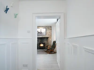 a hallway with a fireplace in a living room at Callander's High Street in Gatehouse of Fleet