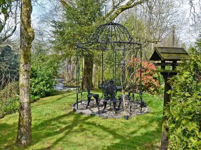 a park bench in the middle of a park at Anvil in Dalbeattie