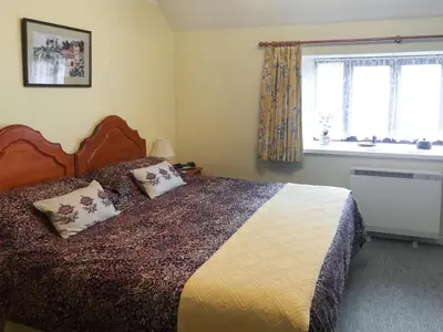 a bedroom with a bed with two pillows on it at Waterwheel in Dalbeattie