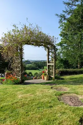 an archway in a garden with flowers on it at Craigmount in Wigtown