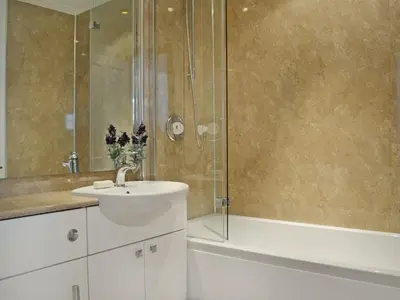 a bathroom with a sink and a shower at Summerlea Cottage in Moffat