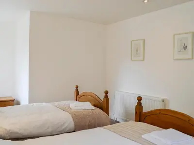 two beds in a bedroom with white walls at Kirroughtree Steading 1 - Uk5859 in Newton Stewart