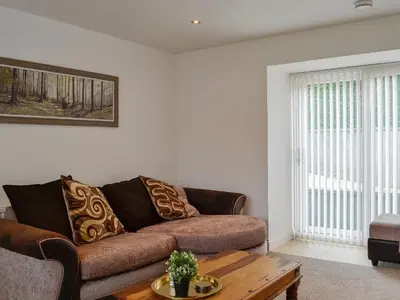 a living room with a couch and a coffee table at Kirroughtree Steading 1 - Uk5859 in Newton Stewart