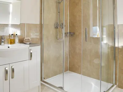 a bathroom with a shower and a sink at Liftingstane Dairy Cottage in Closeburn