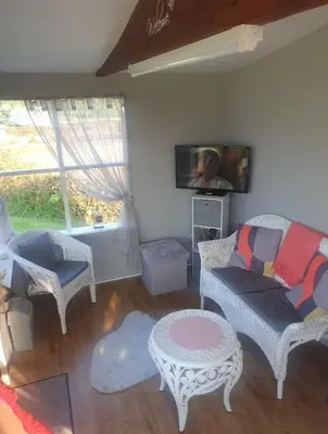a living room with a couch and a tv at Broadlea of Robgill Country Cottage bed and breakfast in Ecclefechan