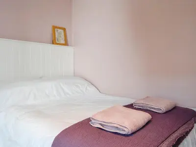 a bed with two towels sitting on top of it at Applegarth in Cockermouth