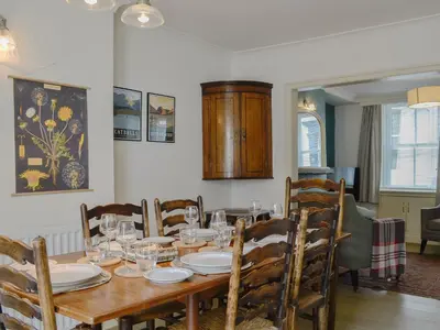 a dining room with a wooden table and chairs at Applegarth in Cockermouth
