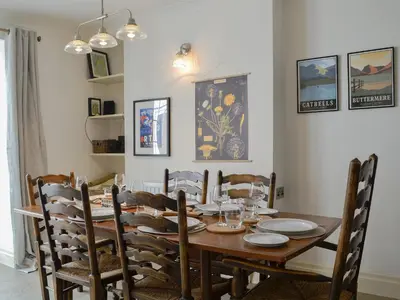 a dining room with a wooden table and chairs at Applegarth in Cockermouth