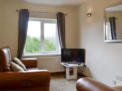 a living room with a couch and a television at Shepherds Bield - Uk1349 in Threlkeld