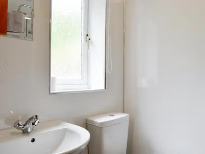 a bathroom with a sink and a toilet and a mirror at Shepherds Bield - Uk1349 in Threlkeld