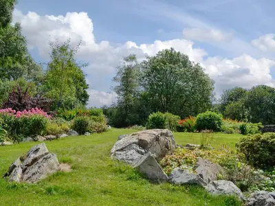 a garden with rocks in the grass and flowers at Wee Cordorcan - Uk5890 in Bargrennan