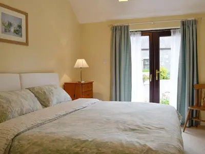 a bedroom with a bed and a window at Wee Cordorcan - Uk5890 in Bargrennan