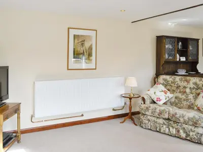 a living room with a couch and a television at Low Cordorcan - Uk5891 in Bargrennan