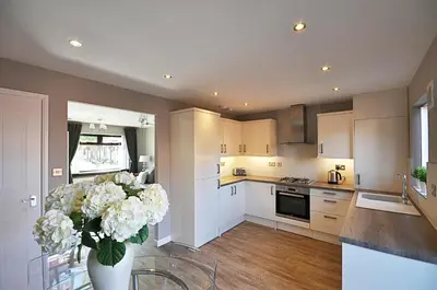 a kitchen with a vase with white flowers in it at The Huntington - Donnini Apartments in Ayr