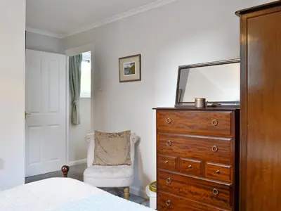 a bedroom with a dresser and a mirror at Jose's At The Grange in Mockerkin