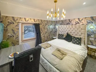 a bedroom with a bed and a table in it at The Golden Crown in Tarbolton