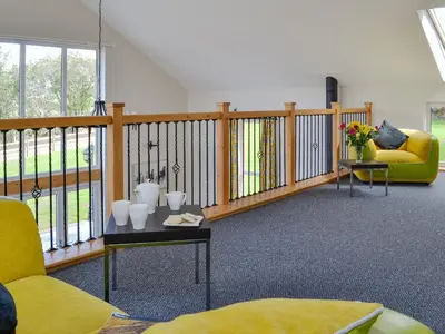 a living room with a couch and a table at Holmegarth in Plumbland
