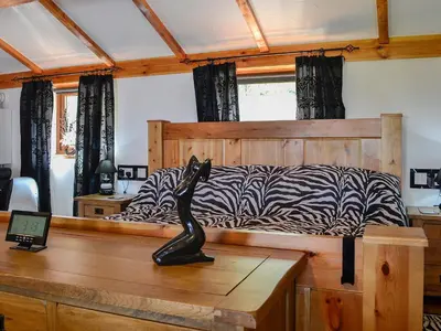 a bedroom with a bed with a zebra print at Swallow Cottage - Ukc3427 in Dalston