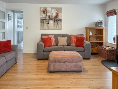 a living room with a couch and a table at Townend Cottage in Aikton