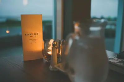 a candle and a candle holder on a table at The Powfoot Hotel, Annan in Annan