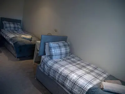 a bedroom with two beds in a room at Abbots Way in Ayr