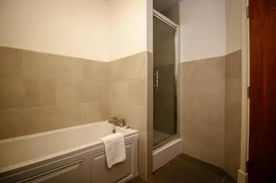 a bathroom with a bath tub and a shower at Turnberry Apartments in Turnberry