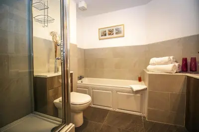 a bathroom with a toilet and a shower at Turnberry Apartments in Turnberry