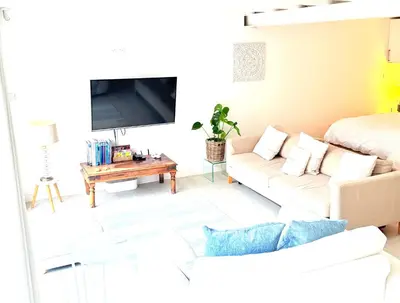 a living room with a couch and a bed at The Retreat Studio in Carlisle