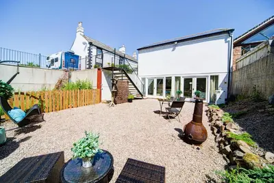 a patio with a table and a large vase at The Retreat Studio in Carlisle