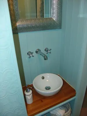 a bathroom with a white sink and a mirror at Osborne House B&B Workington in Workington
