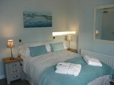 a bedroom with a bed with towels on it at Osborne House B&B Workington in Workington