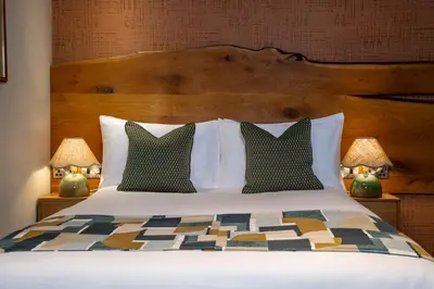 a large bed with two pillows and two lamps at Royal Oak at Keswick in Keswick